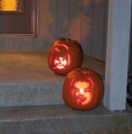 Daniel and Molly pumpkins outside lit with candles on Halloween